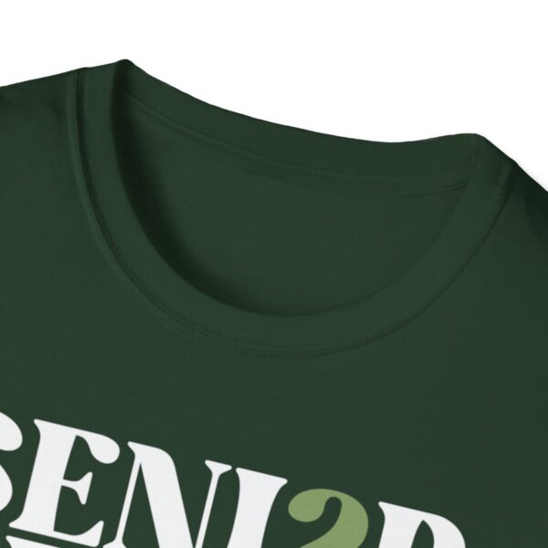 A close-up image of a dark green t-shirt with the text "SENIOR" printed in large white letters, the number "2" visible, suggesting part of the year date, potentially for a graduation shirt design.