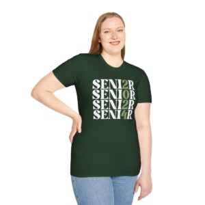 A woman wearing a dark green T-shirt with the word "SENIOR" printed multiple times in a staggered pattern in white letters, paired with blue jeans, standing against a white background.