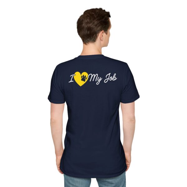 A man viewed from behind wearing a dark blue T-shirt with the text "I (heart) My Job" printed on the back, with the heart symbol replaced by a graphic of a yellow gear.